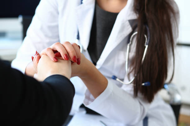 istock Young female doctor holds sick patient by hand 1090733780