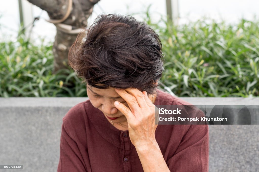 Brain diseases problem cause chronic severe headache migraine. 
Asia female adult look tired and stressed out depressed, having mental problem trouble, medical concept Stroke - Illness Stock Photo