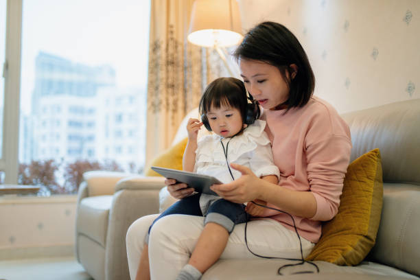 istock Young mother teaching her daughter with a digital tablet 1090737814