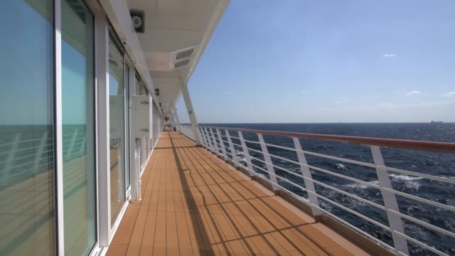 View down the empty walkway on deck of modern cruise ship