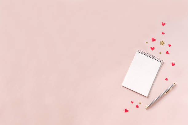 istock Notebook and red hearts isolated on beige background 1090744628