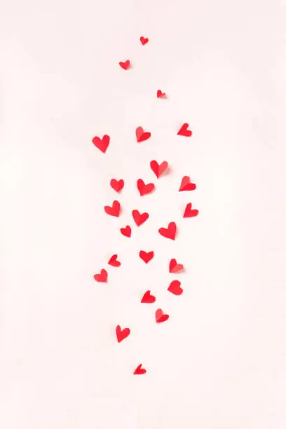 Photo of Red hearts on pink pastel background