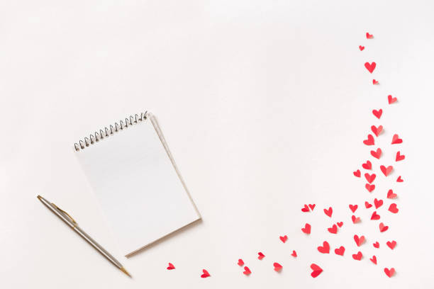 istock Notebook and red hearts isolated on beige background 1090744672