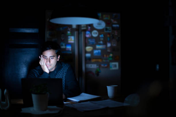 istock Young Adult Studying late in the Kitchen 1090748188