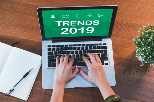 istock top view hand type trends 2019 on laptop keyboard with open notebook and plant on table at home.working with technology. 1090750028