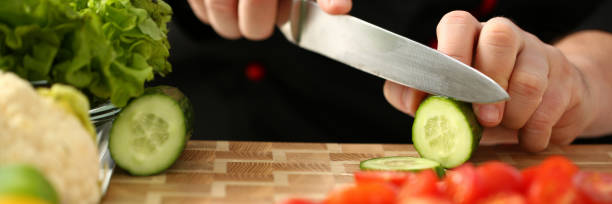 istock Cook holds knife in hand and cuts on 1090750124