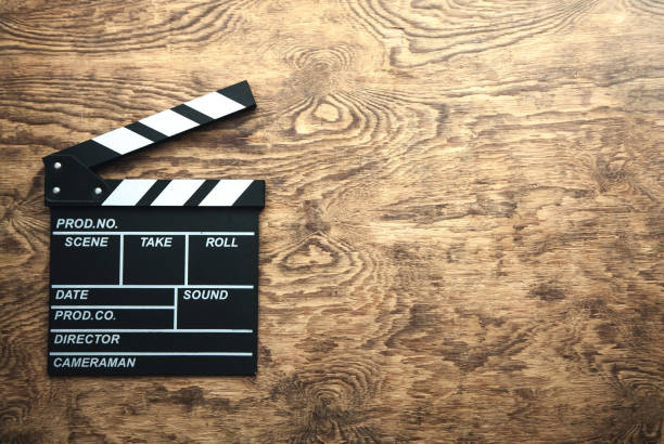 istock Movie clapper on wooden background. 1090755332