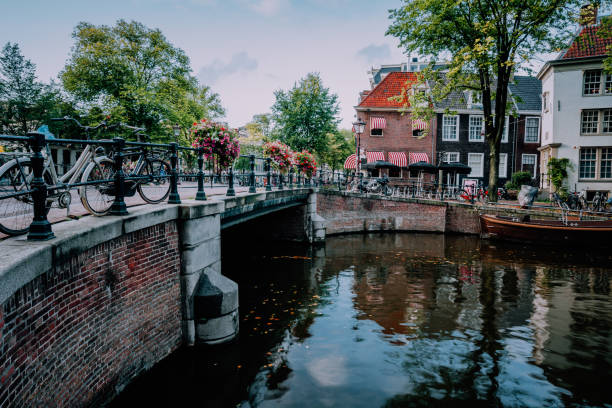 istock Autumnal Amsterdam canal scene with bicycles and bridge. 1090755428