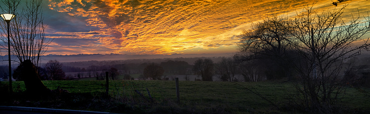 a beautiful sunset in the countryside with orange sky