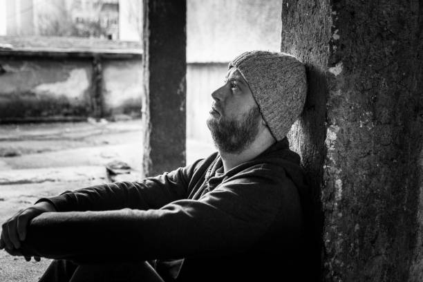 istock Young Homeless Depressed Man Sitting Outdoors in Cold 1090763238