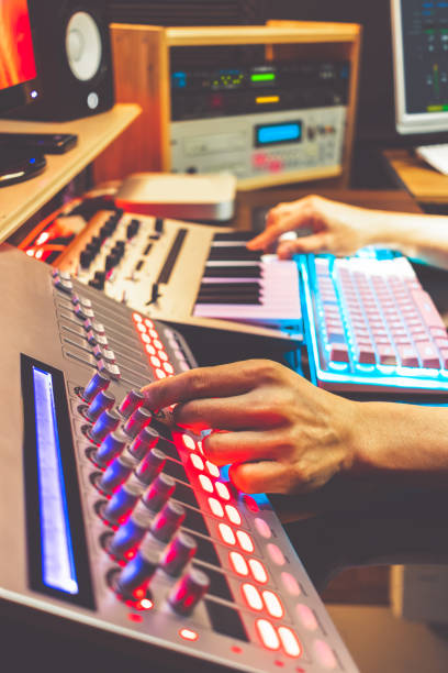 istock male DJ, producer, composer, sound engineer, editor working in sound studio, broadcasting studio, home studio for post production 1090763650
