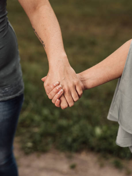 istock Close up of women holding hands 1090767708