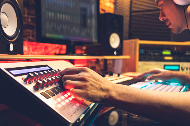istock male DJ, producer, composer, sound engineer, editor working in sound studio, broadcasting studio, home studio for post production 1090770028