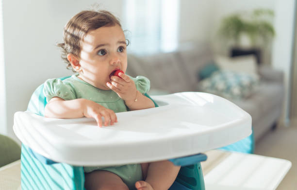 istock Baby girl eating cherry tomato. 1090770206