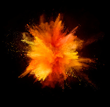 Explosión de polvo de colores sobre fondo negro photo