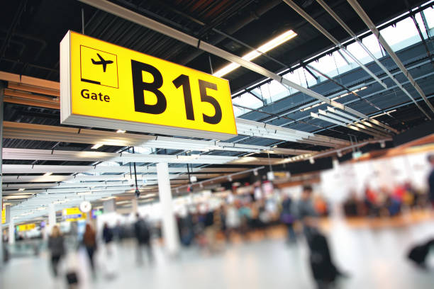 Airport terminal passengers crowd walking in Amsterdam Schiphol, Netherlands