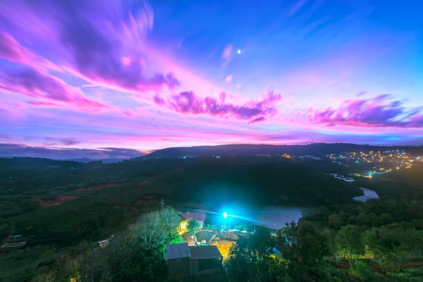 Dawn on plateau in morning with colorful sky, while sun rising from horizon shines down to small village landscape so beautiful idyllic countryside Dalat plateau, Vietnam