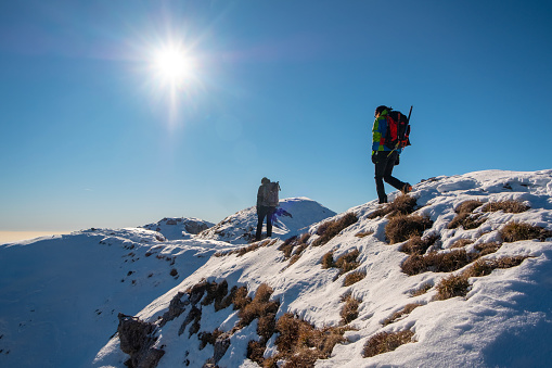 Hikers on snowy mountain range