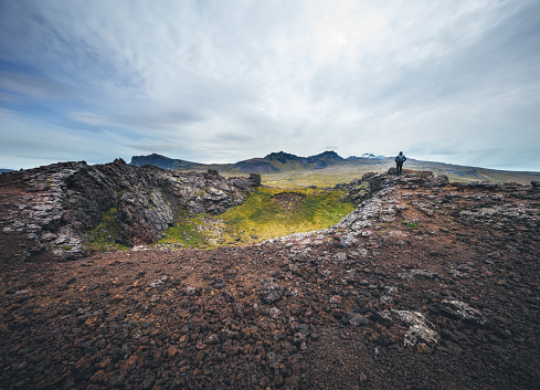 Man standing on the top of volcanic crater (Saxholl crater, Snæfellsnes Peninsula, west Iceland).