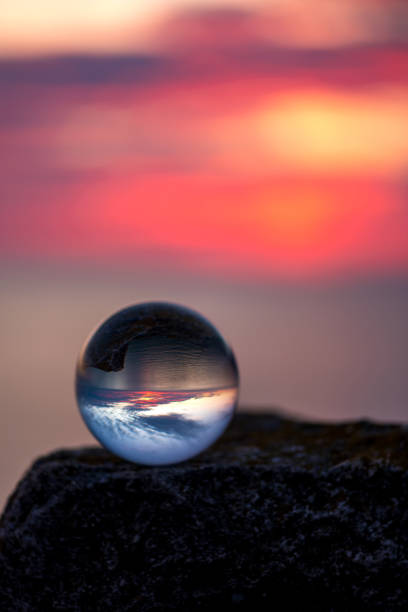 istock Upside down sunset landscape at Cape Kaliakra, Bulgaria, Eastern Europe - reflection in a lensball - selective focus, space for text 1090788522