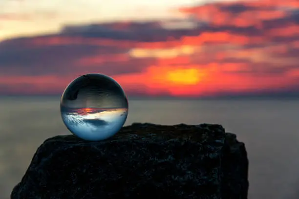 Upside down sunset landscape at Cape Kaliakra, Bulgaria, Eastern Europe - reflection in a lensball - selective focus, space for text