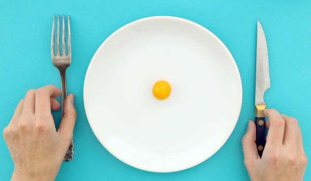 istock Female hands with cutlery and empty plate 1090790472