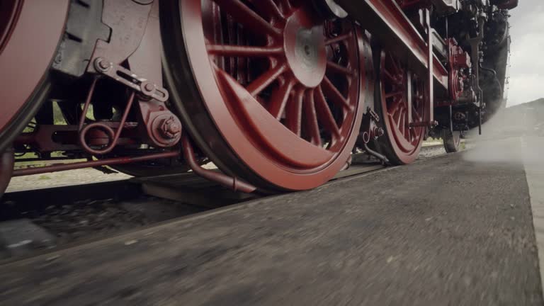 Steam train details of wheels in motion with steam