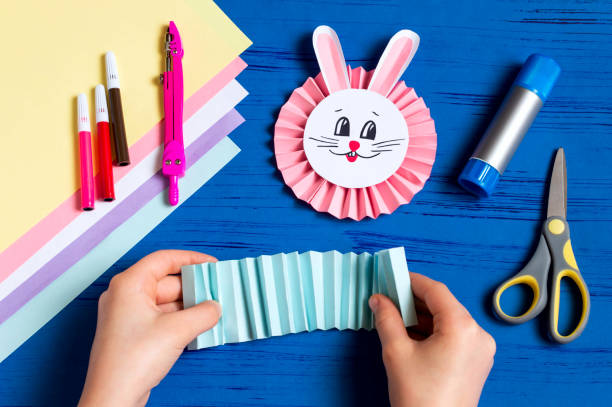 istock Child makes bunnies for Easter decoration. Step 11 1090802984