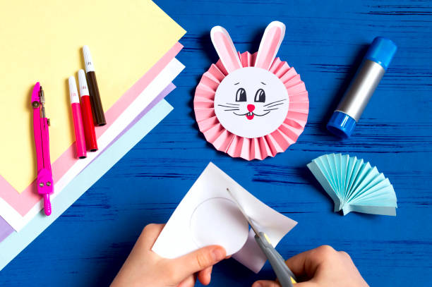 istock Child makes bunnies for Easter decoration. Step 13 1090802988