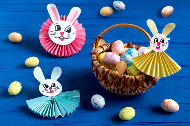 Child makes bunnies for Easter decoration. Step 16 stock photo