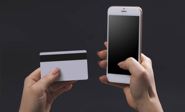 istock female hands hold mobile and bank card 1090805058