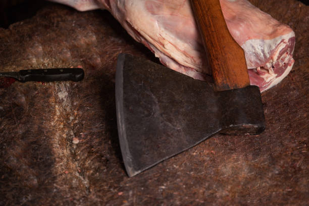 The chopping board, on it lies meat and the axe for cabin