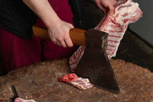 a butcher chopping meat lamb for steaks