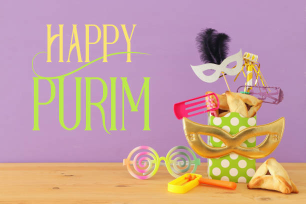 istock Purim celebration concept (jewish carnival holiday) over wooden table and pink background. 1090816866