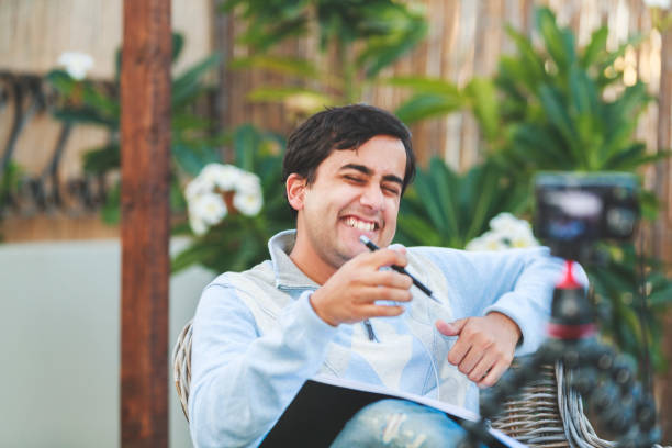 istock Young Vlogger Recording his next Vlog at the Patio 1090819140