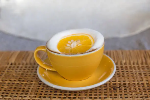 a cup of coffee, orange cafelatte
