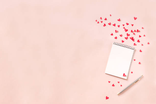istock Notebook and red hearts isolated on beige background 1090825298