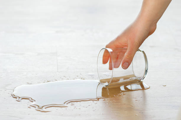 istock drinking glass spilled over the parquet floor 1090825948