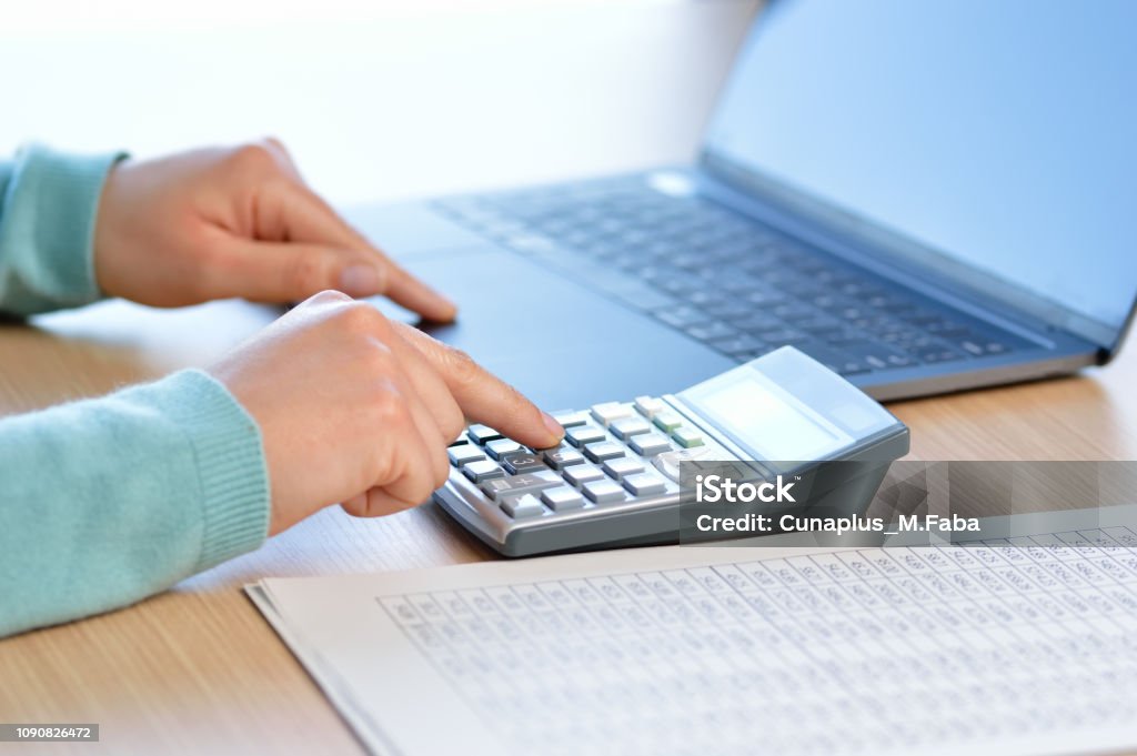 working at the office Businesswoman accounting with calculator at the office Accountancy Stock Photo