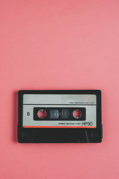 istock Old audio cassette tape on pink background 1090827870