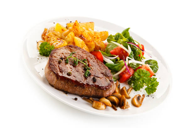 istock Grilled beefsteak, baked potatoes and vegetables on white background 1090831062