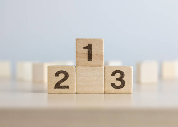 istock Wooden blocks stacking as a podium on white background. Success, win, winner, victory or top ranking concept. 1090834964