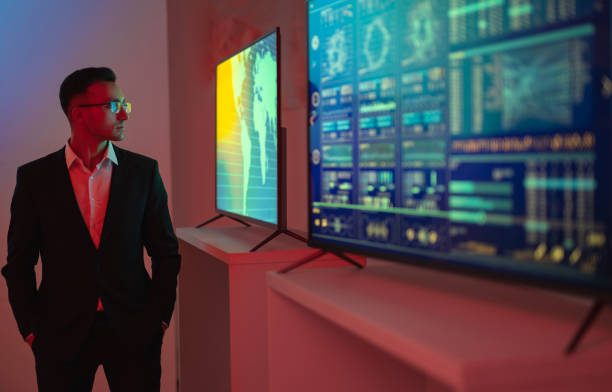 istock The businessman standing near screens with graphs 1090835388