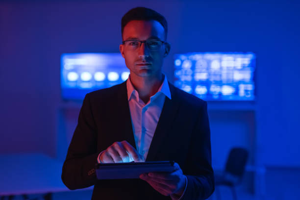 istock The man in glasses with a tablet working in a room with screens 1090835756