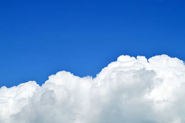 istock A horizontal click of white bright clouds in open bright blue sky. 1090844156