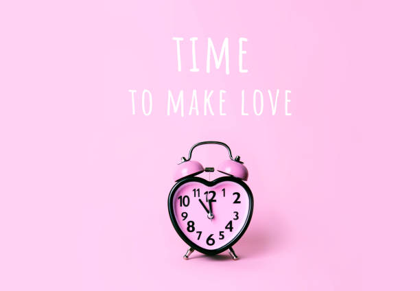 istock Heart shaped clock on pink background. Valentines day and love and duration concept. 1090848590