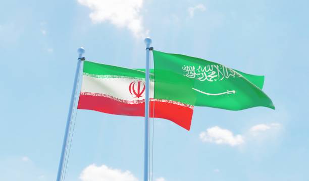 istock Iran and Saudi Arabia, two flags waving against blue sky 1090855598