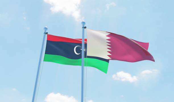 istock Libya and Qatar, two flags waving against blue sky 1090855752