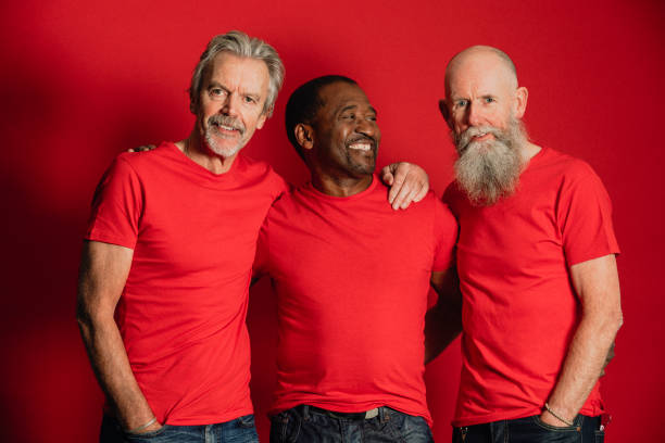 senior male friends laughing - red t shirt imagens e fotografias de stock