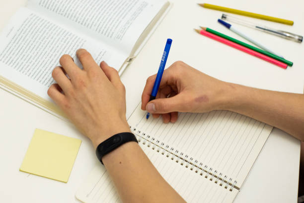 istock Hand writing on white paper. Education and business concept 1090860908